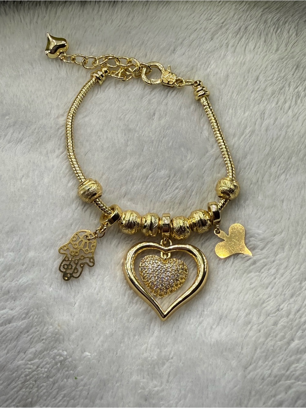 Gold tone stainless steel Heart Charm Bracelet with Hamsa Accent